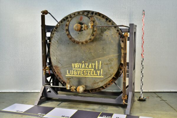 1950s thermal power station alkali tank with sight-glass level indicators, on steel support frame