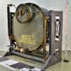 1950s thermal power station alkali tank with sight-glass level indicators, on steel support frame – 2