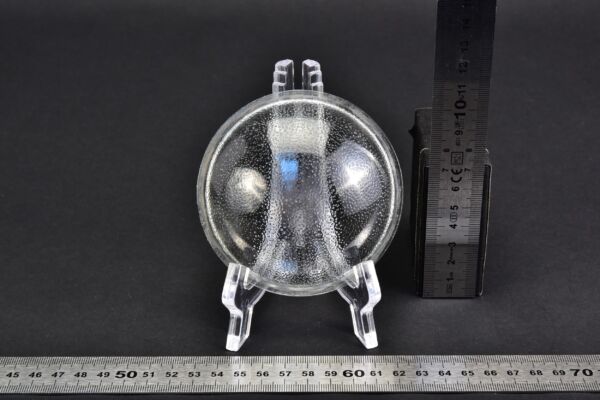 Domed glass lens with a stippled pattern