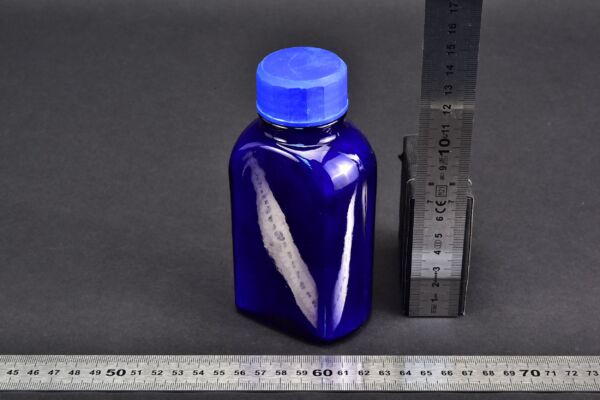 Deep blue glass bottle with blue screw cap