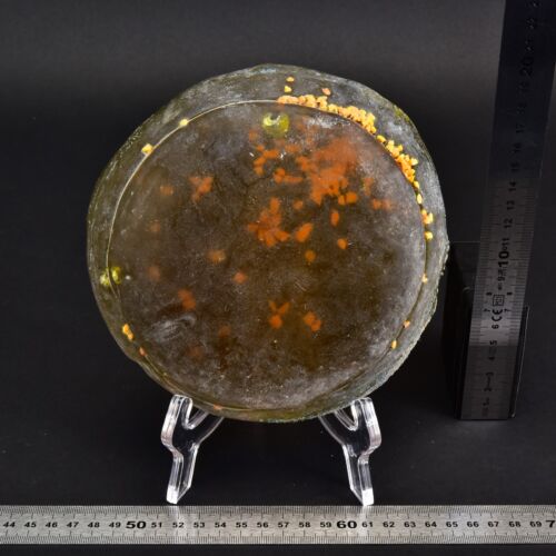 Flat glass disc with yellow granular inclusions Flat glass disc with yellow granular inclusions