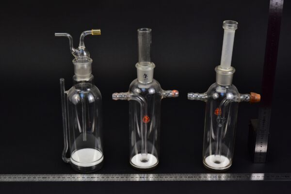 Set of three assorted laboratory gas-washing bottles with sintered-glass discs