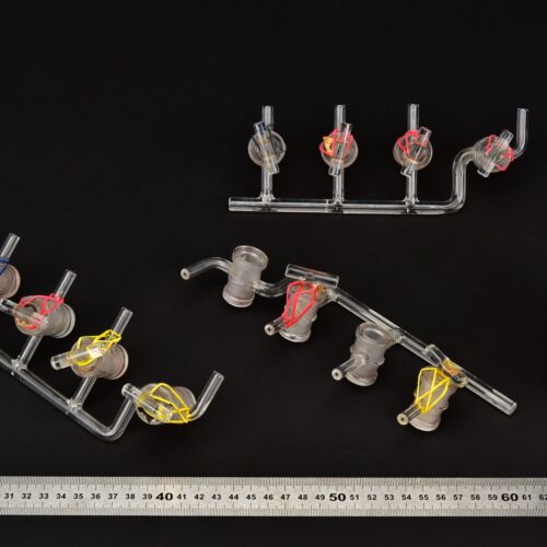 Set of three four-stopcock laboratory glass manifolds, two stopcock plugs missing – No. 2 Set of three four-stopcock laboratory glass manifolds, two stopcock plugs missing – No. 2