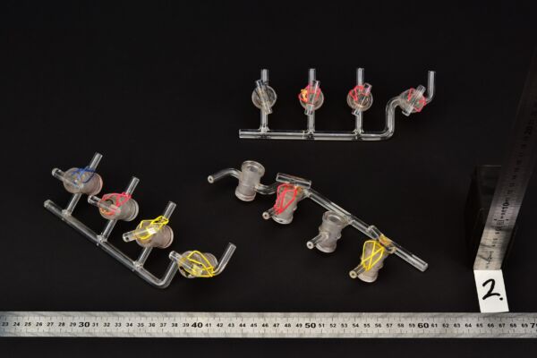 Set of three four-stopcock laboratory glass manifolds, two stopcock plugs missing – No. 2 Set of three four-stopcock laboratory glass manifolds, two stopcock plugs missing – No. 2