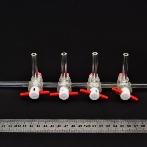 Four-stopcock laboratory glass manifold with red-and-white plugs Four-stopcock laboratory glass manifold with red-and-white plugs